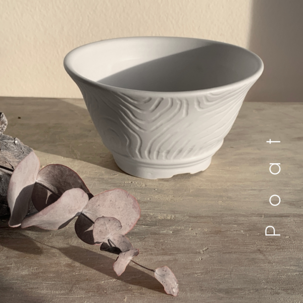 Vista frontal de POAT, maceta de bonsái en porcelana mate con relieve tallado.